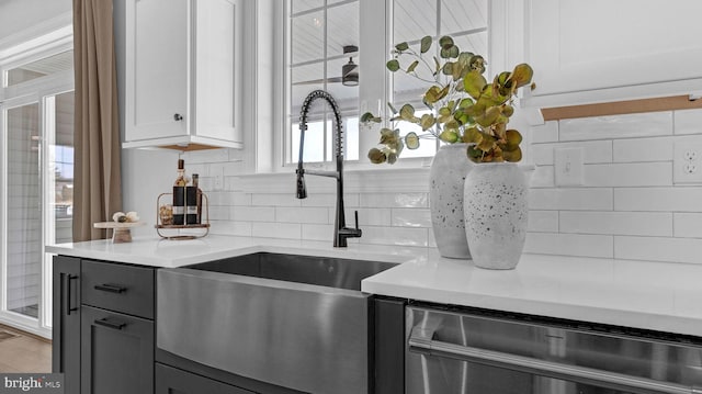 4389 Taviston Ct E, Emmaus, PA 18049 - kitchen with a sink, backsplash, light countertops, stainless steel dishwasher, and gray cabinetry