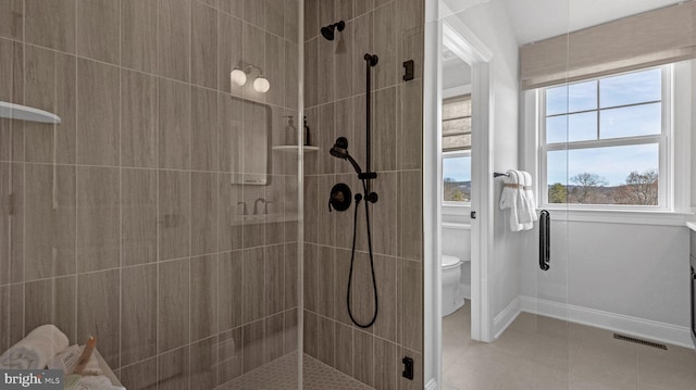 4389 Taviston Ct E, Emmaus, PA 18049 - bathroom with toilet, tiled shower, tile patterned flooring, and baseboards