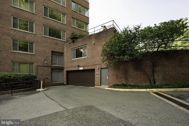 4200 Cathedral Ave NW Unit 615, Washington, DC 20016 - view of property with asphalt driveway and a garage