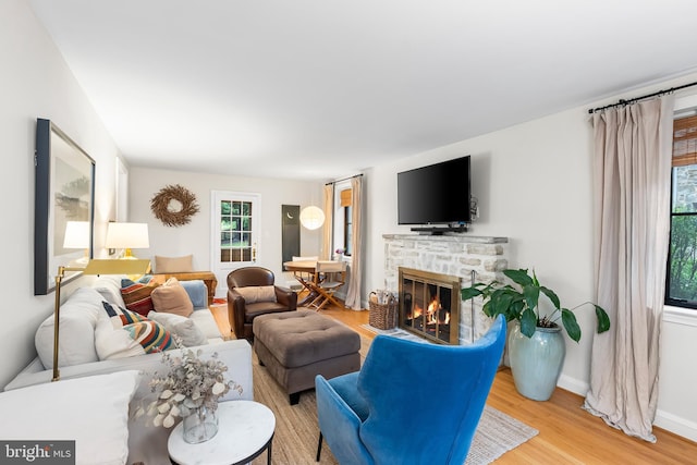 715 Morningside Dr, Towson, MD 21204 - living area with a fireplace, light wood-style floors, and baseboards