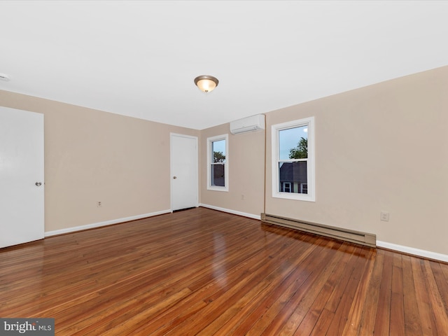 21 E D St, Brunswick, MD 21716 - unfurnished room featuring a baseboard heating unit, wood-type flooring, a wall mounted AC, and baseboards
