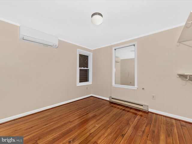 21 E D St, Brunswick, MD 21716 - unfurnished room featuring a baseboard heating unit, an AC wall unit, hardwood / wood-style floors, ornamental molding, and baseboards