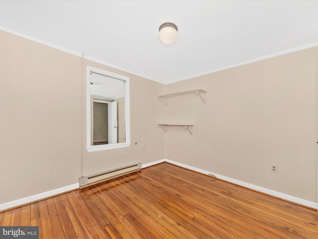 21 E D St, Brunswick, MD 21716 - empty room with a baseboard heating unit, wood-type flooring, baseboards, and crown molding