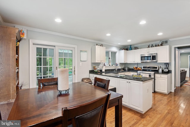 15118 Briarcliff Manor Way, Burtonsville, MD 20866 - kitchen with appliances with stainless steel finishes, ornamental molding, dark countertops, white cabinets, and light wood-style floors