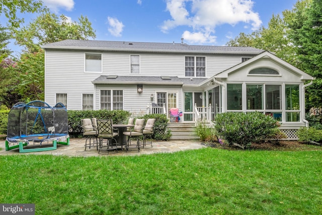 15118 Briarcliff Manor Way, Burtonsville, MD 20866 - rear view of house with a sunroom, a patio, a trampoline, and a lawn