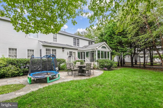 15118 Briarcliff Manor Way, Burtonsville, MD 20866 - rear view of house with a trampoline, a patio area, a sunroom, and roof with shingles