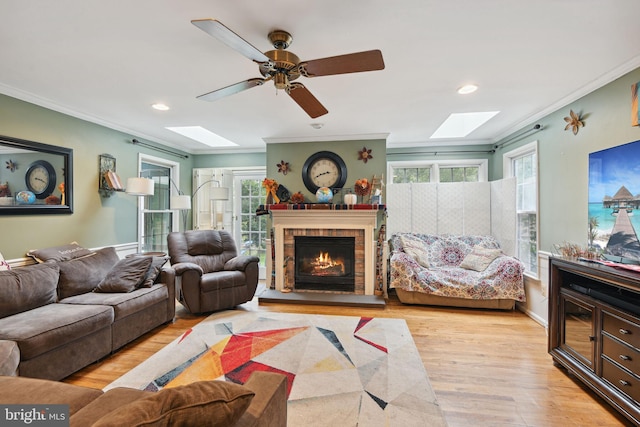 15118 Briarcliff Manor Way, Burtonsville, MD 20866 - living room with a skylight, ornamental molding, wood finished floors, a brick fireplace, and recessed lighting
