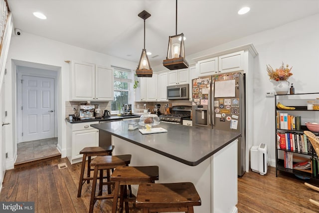 1810 Francis St, Philadelphia, PA 19130 - kitchen featuring appliances with stainless steel finishes, dark countertops, dark wood-style floors, and recessed lighting