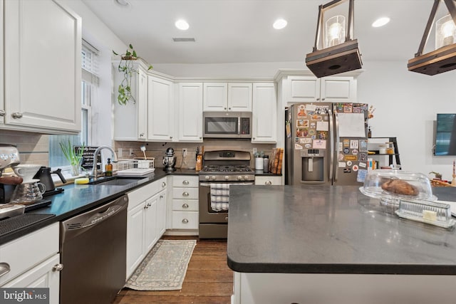 1810 Francis St, Philadelphia, PA 19130 - kitchen with appliances with stainless steel finishes, a sink, dark countertops, white cabinets, and tasteful backsplash