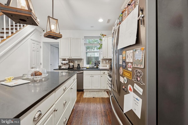 1810 Francis St, Philadelphia, PA 19130 - kitchen featuring stainless steel appliances, dark countertops, white cabinetry, dark wood finished floors, and a sink