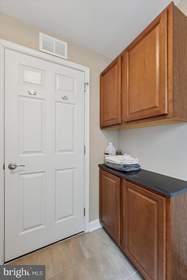 1810 Francis St, Philadelphia, PA 19130 - laundry room featuring light tile patterned floors and baseboards