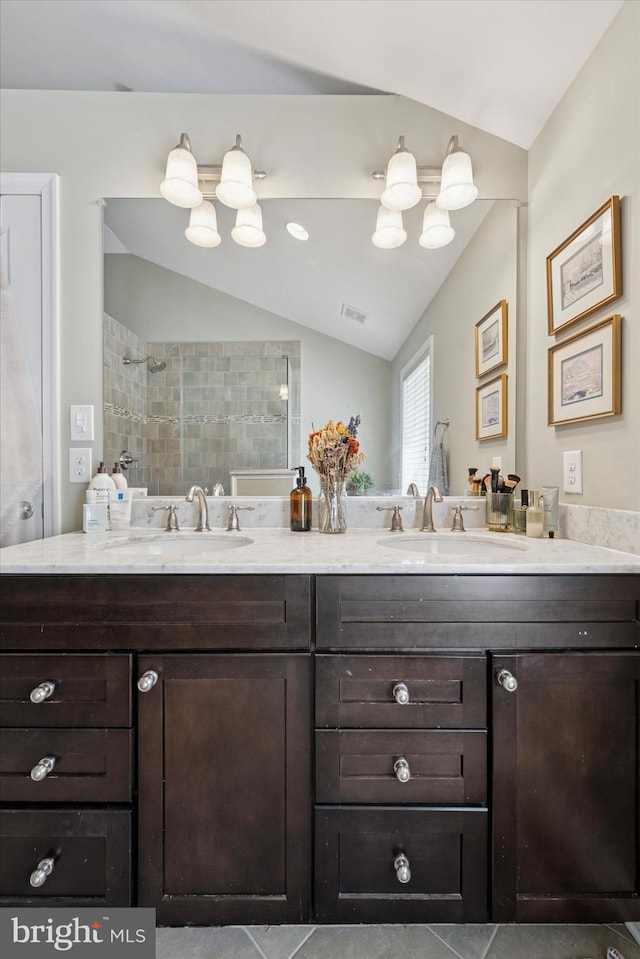 1810 Francis St, Philadelphia, PA 19130 - bathroom featuring lofted ceiling, double vanity, tiled shower, and tile patterned flooring