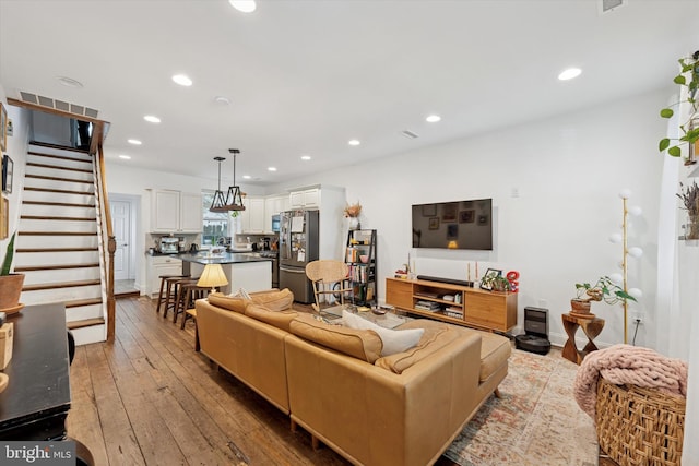 1810 Francis St, Philadelphia, PA 19130 - living room with recessed lighting, hardwood / wood-style floors, and stairway