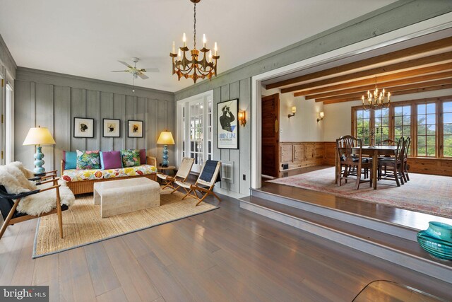 22693 St Louis Rd, Middleburg, VA 20117 - living room with a chandelier, wood finished floors, a ceiling fan, wood walls, and wainscoting
