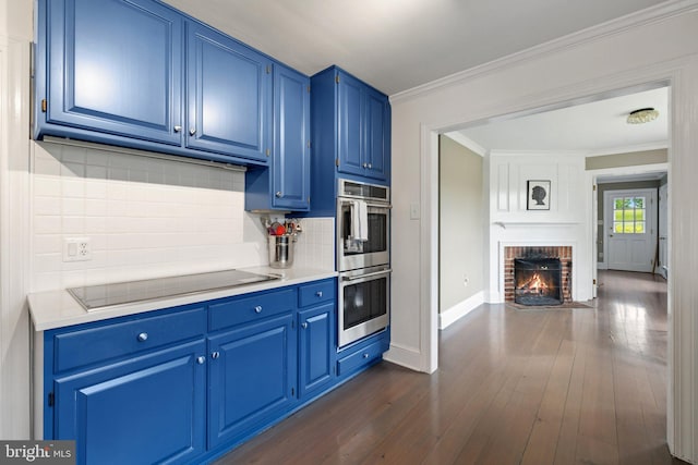 22693 St Louis Rd, Middleburg, VA 20117 - kitchen with blue cabinetry, double oven, black electric cooktop, dark wood-type flooring, and crown molding