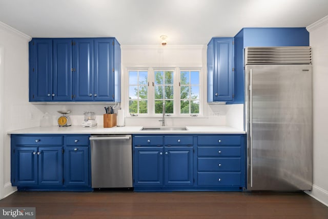 22693 St Louis Rd, Middleburg, VA 20117 - kitchen with stainless steel appliances, blue cabinetry, a sink, and ornamental molding