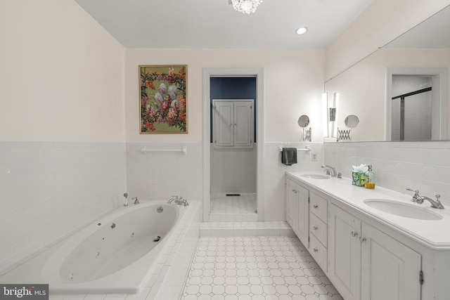22693 St Louis Rd, Middleburg, VA 20117 - bathroom featuring a shower stall, a whirlpool tub, double vanity, tile walls, and wainscoting