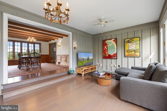 22693 St Louis Rd, Middleburg, VA 20117 - living area featuring a chandelier, wood finished floors, ceiling fan, wood walls, and a decorative wall