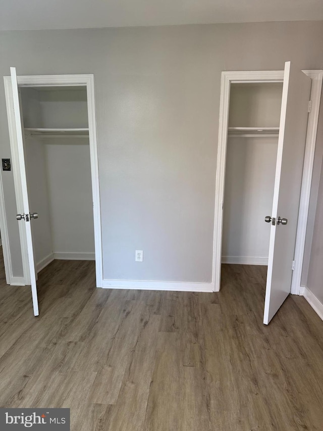 5104 Columbia Pike Unit 6, Arlington, VA 22204 - unfurnished bedroom featuring wood finished floors and two closets