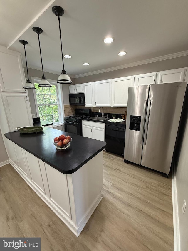 5104 Columbia Pike Unit 6, Arlington, VA 22204 - kitchen with black appliances, dark countertops, white cabinetry, a peninsula, and light wood-style flooring