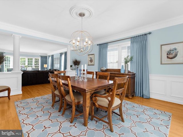 116 Colony Xing, Edgewater, MD 21037 - dining space featuring ornamental molding, ornate columns, a chandelier, light wood-type flooring, and wainscoting