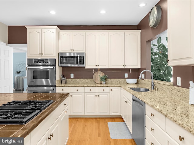 116 Colony Xing, Edgewater, MD 21037 - kitchen featuring appliances with stainless steel finishes, a sink, light wood-style floors, white cabinets, and recessed lighting