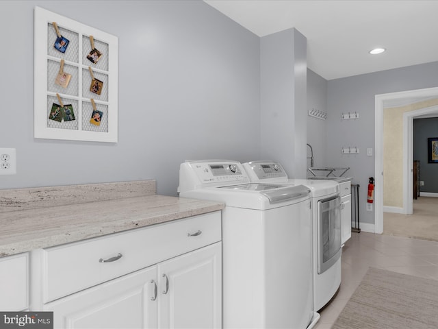 116 Colony Xing, Edgewater, MD 21037 - laundry room featuring washing machine and clothes dryer, cabinet space, light tile patterned flooring, and baseboards