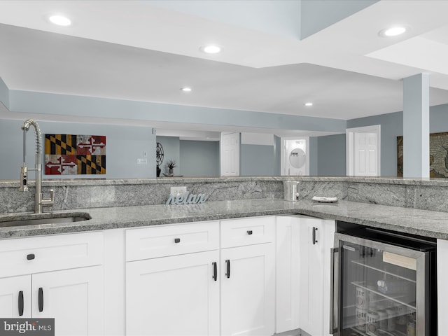 116 Colony Xing, Edgewater, MD 21037 - kitchen featuring beverage cooler, a sink, light stone countertops, white cabinets, and recessed lighting