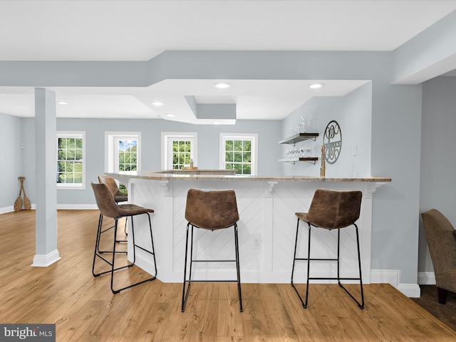 116 Colony Xing, Edgewater, MD 21037 - kitchen with a kitchen breakfast bar, baseboards, light wood-type flooring, recessed lighting, and light stone counters