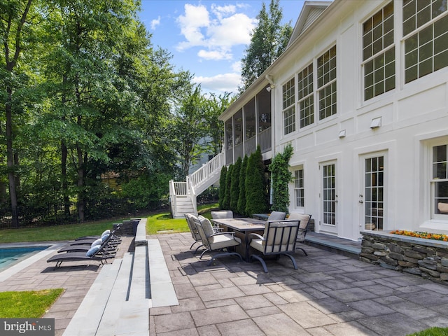 116 Colony Xing, Edgewater, MD 21037 - view of patio / terrace featuring stairway, a sunroom, outdoor dining space, and an outdoor pool