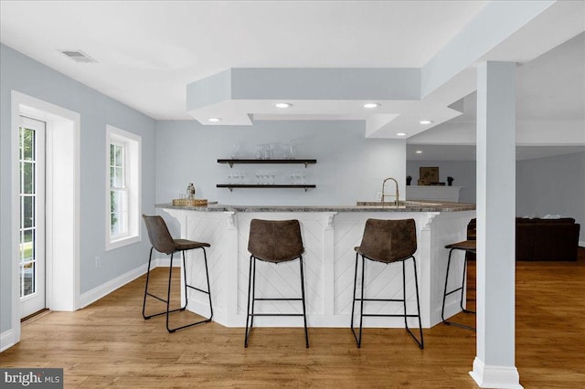 116 Colony Xing, Edgewater, MD 21037 - kitchen featuring a kitchen bar, light wood-style floors, recessed lighting, light stone countertops, and baseboards