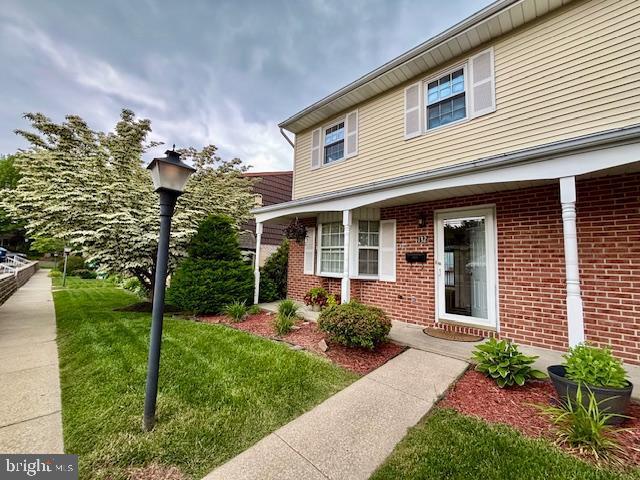 132 Popodickon Dr, Boyertown, PA 19512 - entrance to property featuring brick siding and a lawn