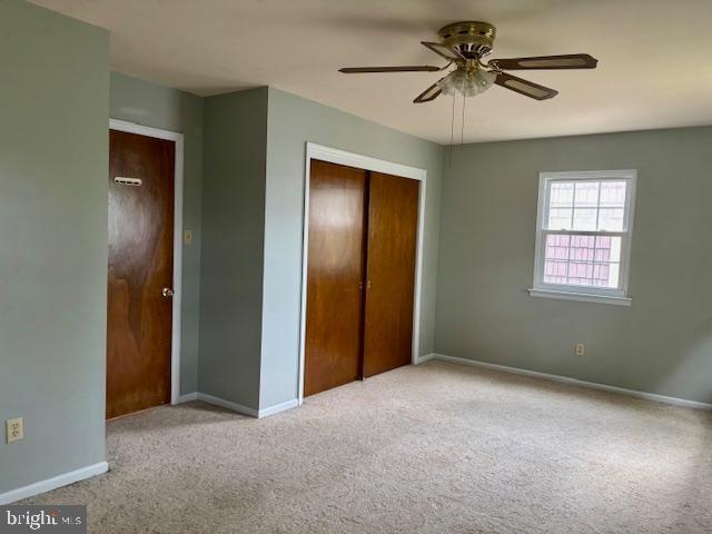 132 Popodickon Dr, Boyertown, PA 19512 - unfurnished bedroom with carpet, a closet, baseboards, and a ceiling fan