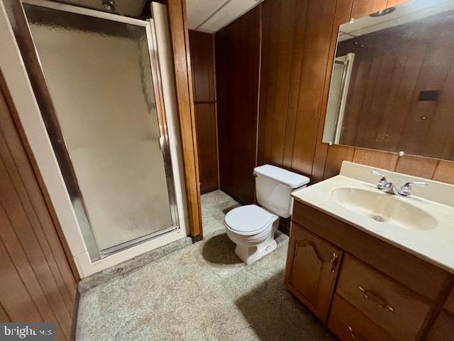 132 Popodickon Dr, Boyertown, PA 19512 - bathroom with a stall shower, vanity, toilet, and wooden walls