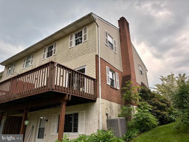 132 Popodickon Dr, Boyertown, PA 19512 - rear view of house featuring a chimney, a wooden deck, and brick siding