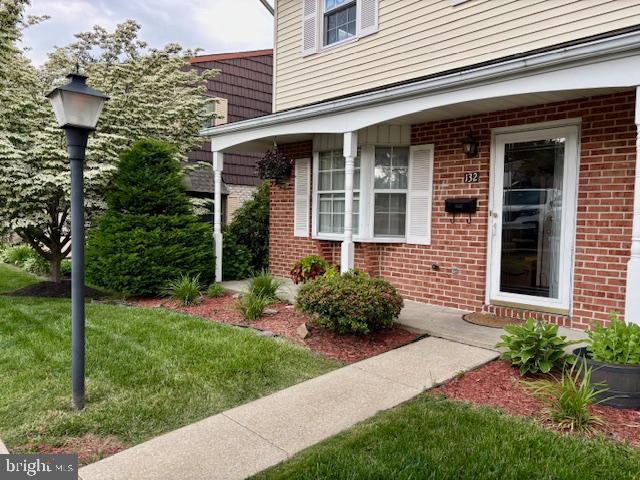 132 Popodickon Dr, Boyertown, PA 19512 - doorway to property featuring brick siding and a lawn