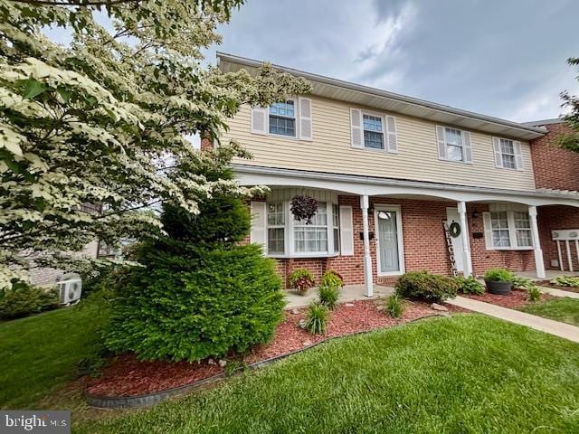 132 Popodickon Dr, Boyertown, PA 19512 - view of front of house with a front lawn, brick siding, and a porch