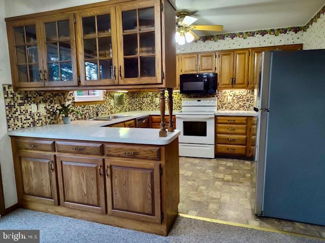 132 Popodickon Dr, Boyertown, PA 19512 - kitchen featuring freestanding refrigerator, black microwave, white electric range oven, light countertops, and decorative backsplash