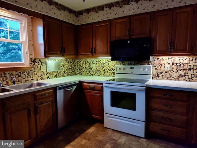 132 Popodickon Dr, Boyertown, PA 19512 - kitchen with black microwave, white electric range, dishwasher, a sink, and light countertops