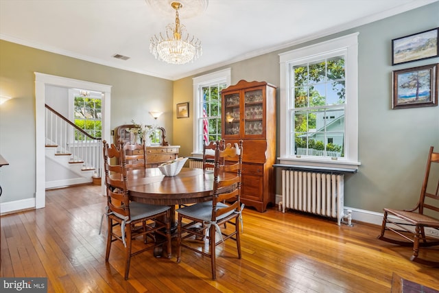 402 W Masonic View Ave, Alexandria, VA 22301 - dining room with radiator heating unit, a chandelier, plenty of natural light, hardwood / wood-style floors, and crown molding