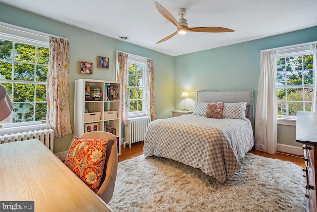 402 W Masonic View Ave, Alexandria, VA 22301 - bedroom featuring radiator heating unit, wood finished floors, and ceiling fan