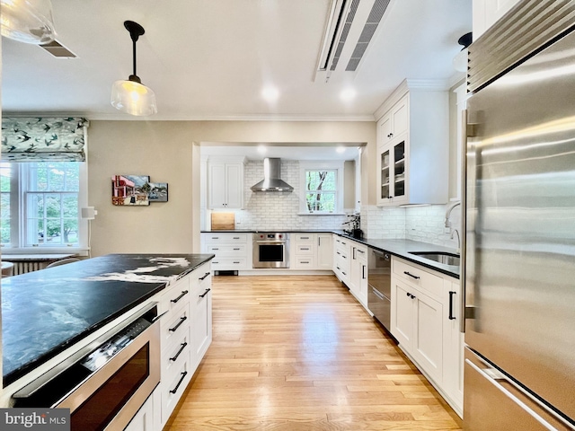 402 W Masonic View Ave, Alexandria, VA 22301 - kitchen featuring stainless steel appliances, a sink, dark countertops, wall chimney range hood, and crown molding