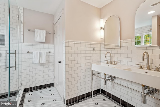 402 W Masonic View Ave, Alexandria, VA 22301 - bathroom featuring tile walls, tile patterned flooring, a shower stall, wainscoting, and a sink