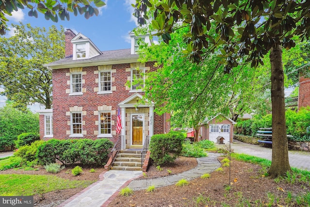 402 W Masonic View Ave, Alexandria, VA 22301 - view of front facade with brick siding, a chimney, concrete driveway, and a garage