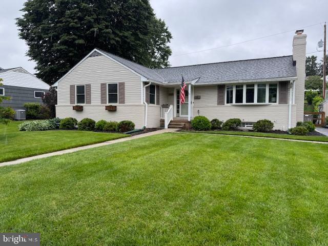 1606 Jeffers Rd, Baltimore, MD 21204 - view of front facade with a front lawn, a chimney, and cooling unit