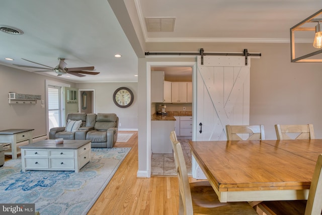 1606 Jeffers Rd, Baltimore, MD 21204 - dining room with ceiling fan, light wood-style flooring, a barn door, ornamental molding, and recessed lighting