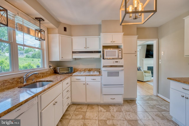 1606 Jeffers Rd, Baltimore, MD 21204 - kitchen featuring a warming drawer, white appliances, under cabinet range hood, a sink, and white cabinets