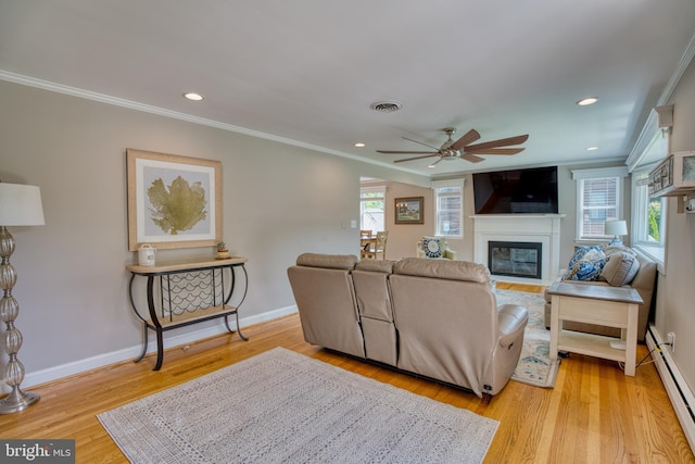 1606 Jeffers Rd, Baltimore, MD 21204 - living area with a baseboard heating unit, ceiling fan, crown molding, a fireplace with flush hearth, and light wood finished floors
