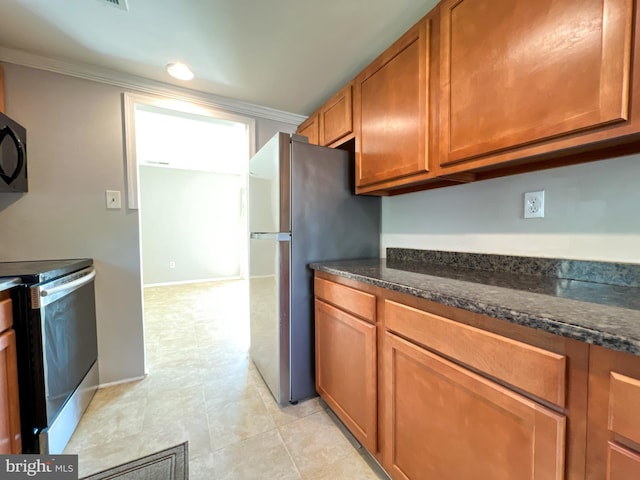 131 Arundel Rd, Pasadena, MD 21122 - kitchen featuring stainless steel appliances, brown cabinetry, dark stone countertops, and ornamental molding