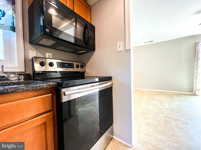 131 Arundel Rd, Pasadena, MD 21122 - kitchen featuring black microwave, stainless steel electric stove, brown cabinetry, and baseboards
